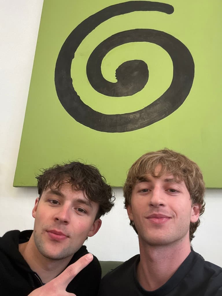 Two friends beneath a spiral painting at Granola’s offices in London.